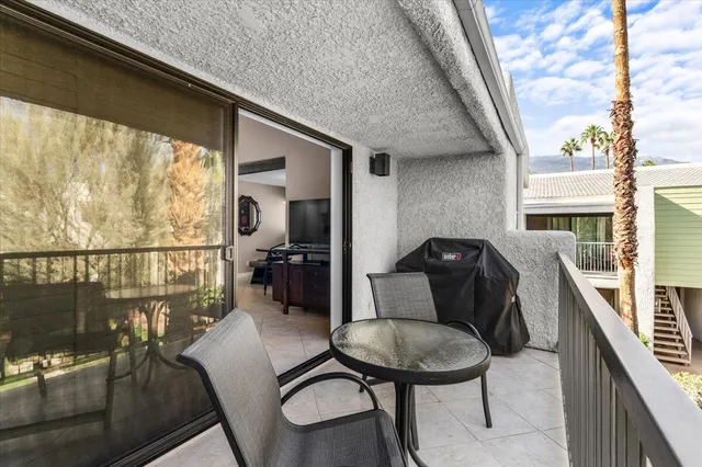 a balcony view with a seating space