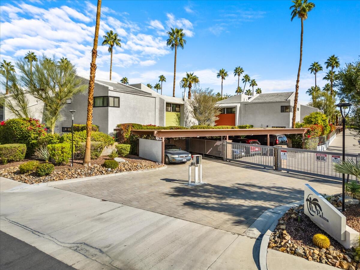 3155 Ramon Road, Unit 312 Palm Springs, CA 92264 - Photo 33 of 34 a view of a patio with table and chairs potted plants