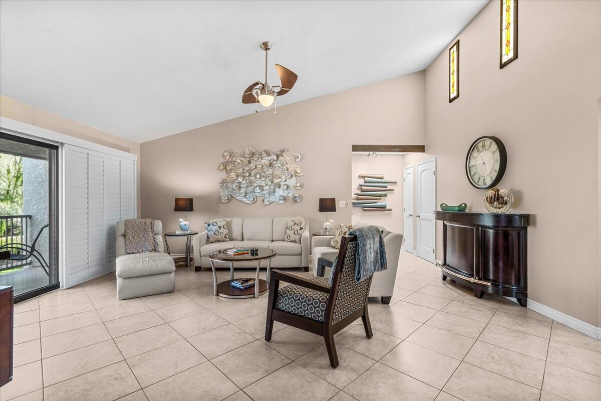 3155 Ramon Road, Unit 312 Palm Springs, CA 92264 - Photo 4 of 34 a living room with furniture a window and a clock