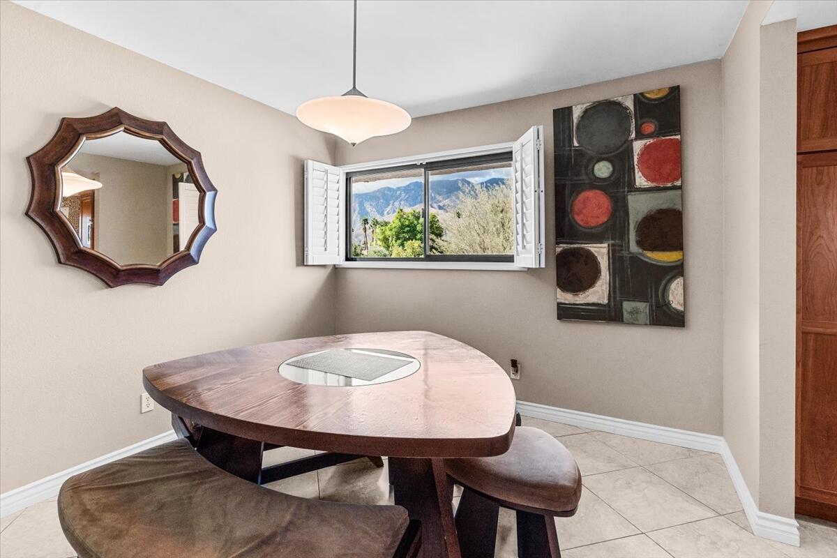 3155 Ramon Road, Unit 312 Palm Springs, CA 92264 - Photo 10 of 34 a view of a dining room with furniture and wooden floor