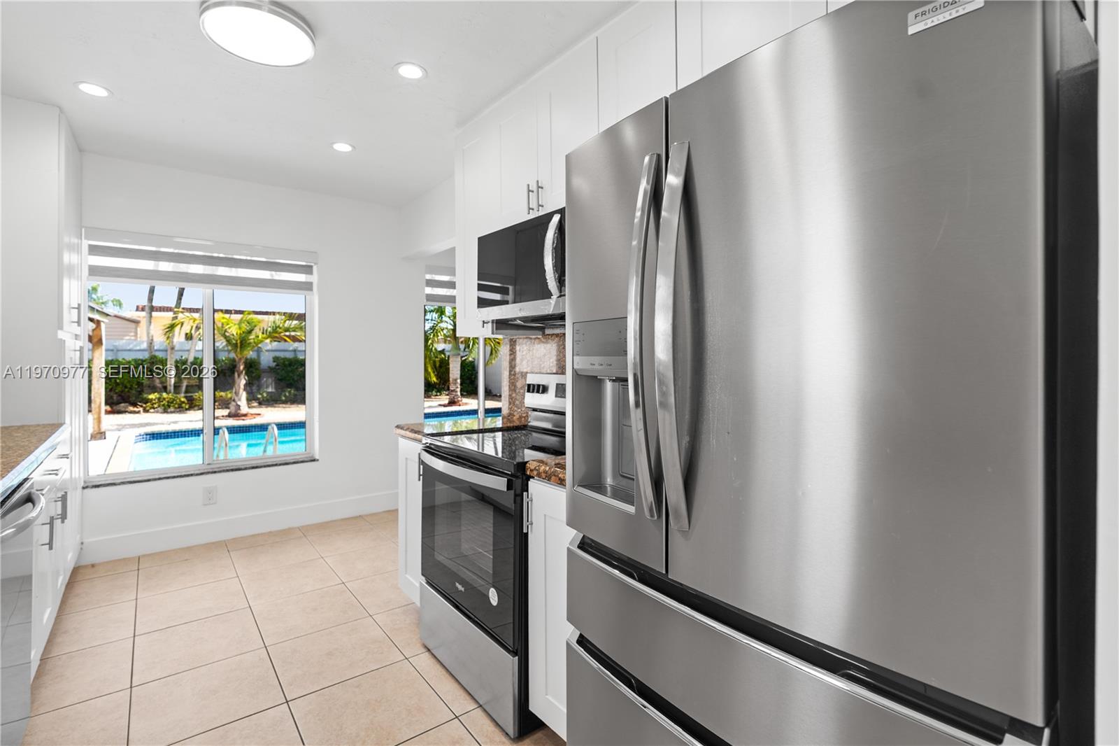 5103 Southwest 128th Place Miami, FL 33175 - Photo 11 of 38 a kitchen with stainless steel appliances a refrigerator and a sink