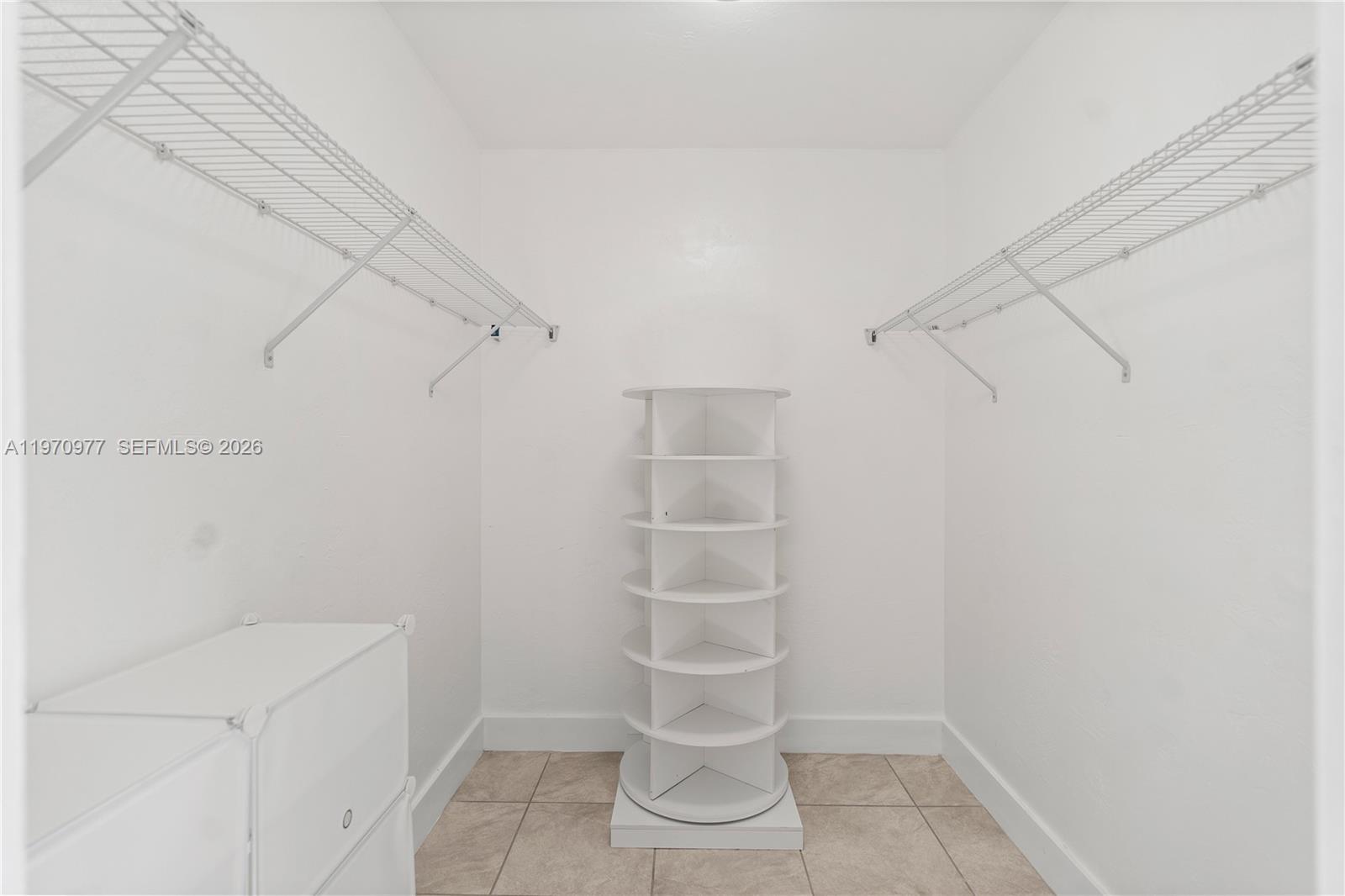 5103 Southwest 128th Place Miami, FL 33175 - Photo 28 of 38 a view of walk in closet with empty racks