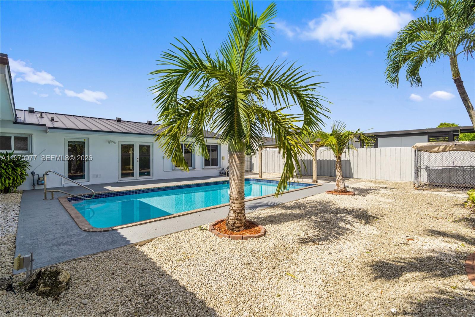 5103 Southwest 128th Place Miami, FL 33175 - Photo 34 of 38 a view of a house with swimming pool and sitting area