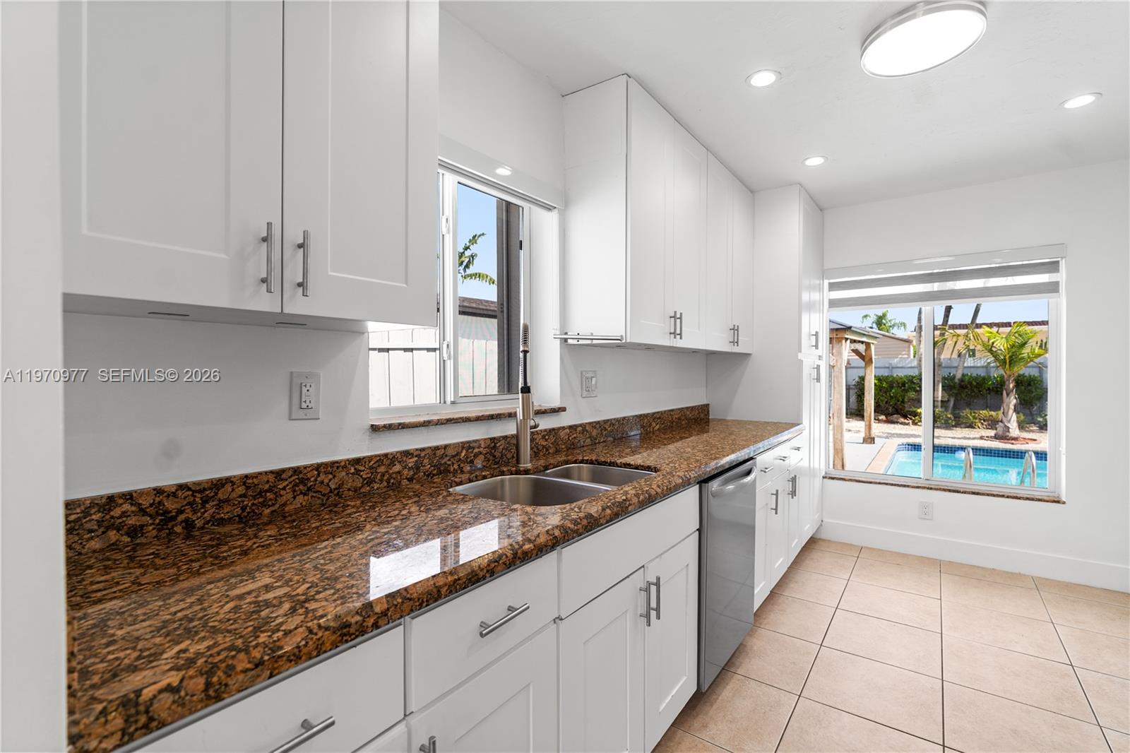 5103 Southwest 128th Place Miami, FL 33175 - Photo 10 of 38 a kitchen with granite countertop a sink and a stove