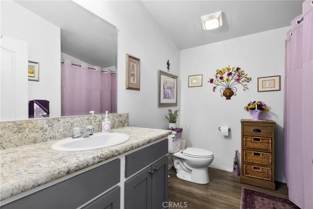 3700 Buchanan Street, Unit 108 Riverside, CA 92503 - Photo 14 of 31 a bathroom with a granite countertop sink mirror and toilet