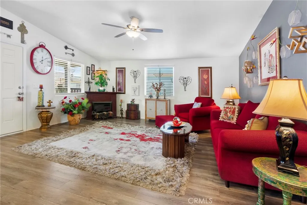 3700 Buchanan Street, Unit 108 Riverside, CA 92503 - Photo 6 of 31 a living room with furniture a chandelier and a fireplace