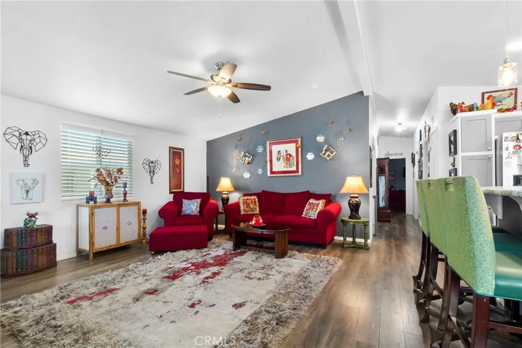3700 Buchanan Street, Unit 108 Riverside, CA 92503 - Photo 7 of 31 a living room with furniture a couch and dresser with wooden floor