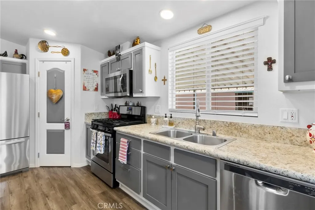 3700 Buchanan Street, Unit 108 Riverside, CA 92503 - Photo 9 of 31 a kitchen with stainless steel appliances granite countertop a sink and a refrigerator
