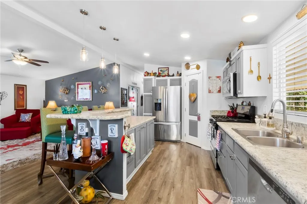 3700 Buchanan Street, Unit 108 Riverside, CA 92503 - Photo 10 of 31 a kitchen that has a lot of cabinets a sink and a refrigerator