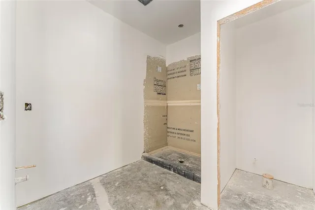 a bathroom with a granite countertop sink and shower
