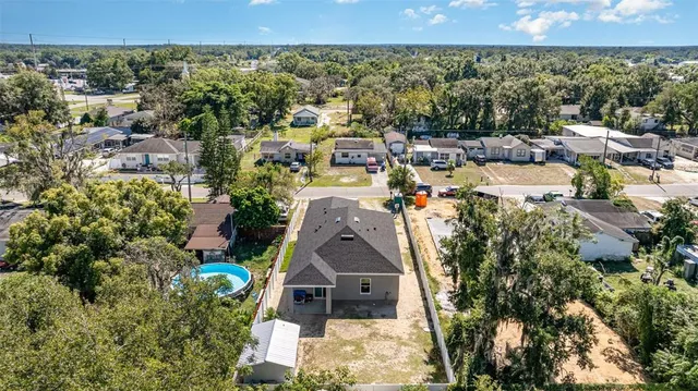 an aerial view of a house with a yard