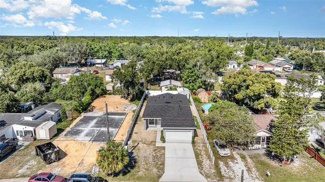an aerial view of a house with a yard