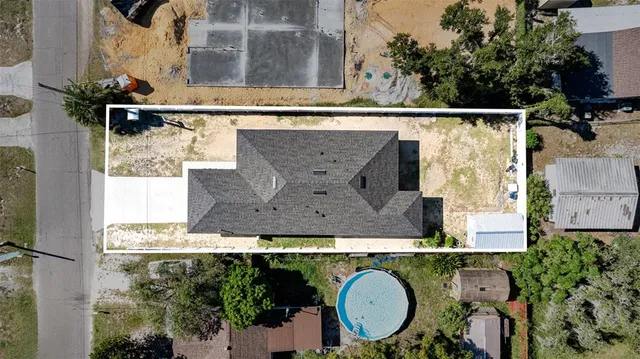 an aerial view of a house with a yard