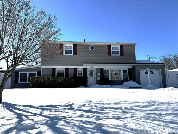 a view of a house with a snow in the background