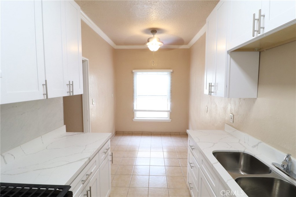 925 North Lacy Street, Unit 4 Santa Ana, CA 92701 - Photo 13 of 20 a kitchen with a stove a sink and chandelier