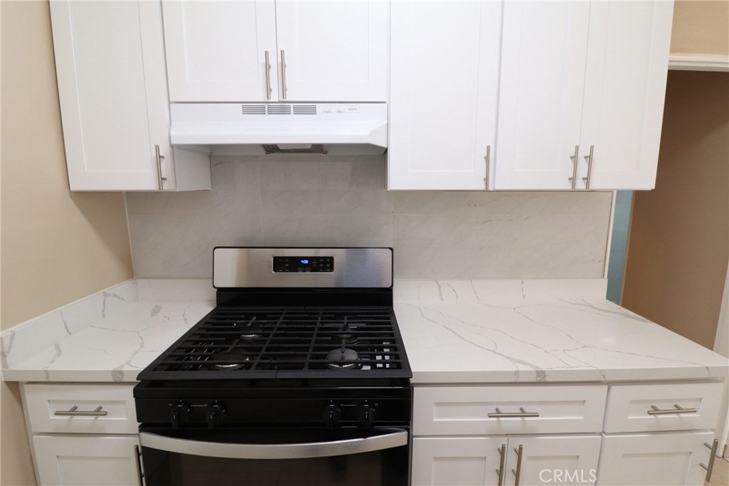 925 North Lacy Street, Unit 4 Santa Ana, CA 92701 - Photo 14 of 20 a close view of a stove a microwave and cabinets