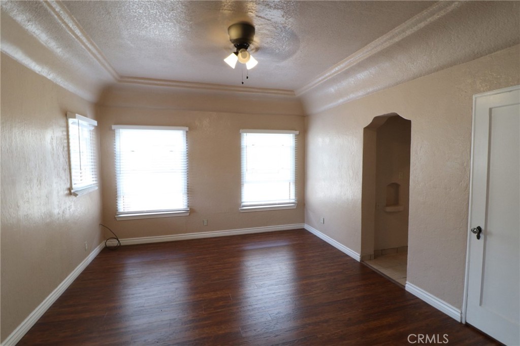 925 North Lacy Street, Unit 4 Santa Ana, CA 92701 - Photo 3 of 20 a view of an empty room with wooden floor and a window