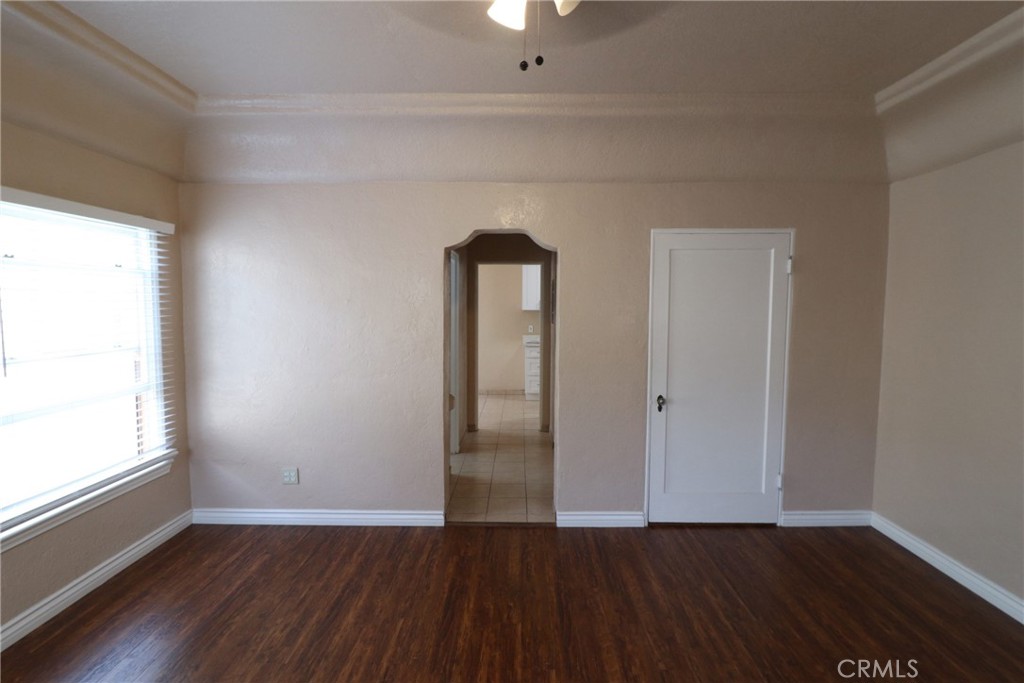 925 North Lacy Street, Unit 4 Santa Ana, CA 92701 - Photo 5 of 20 a view of an empty room with wooden floor and a window
