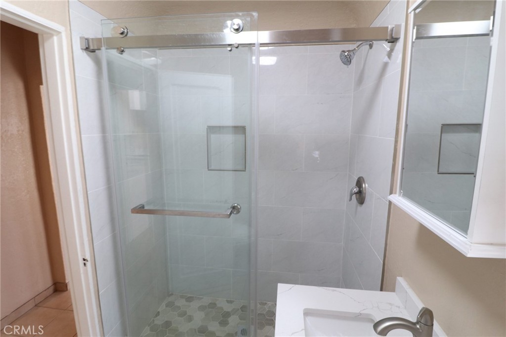 925 North Lacy Street, Unit 4 Santa Ana, CA 92701 - Photo 8 of 20 a bathroom with a shower and a toilet