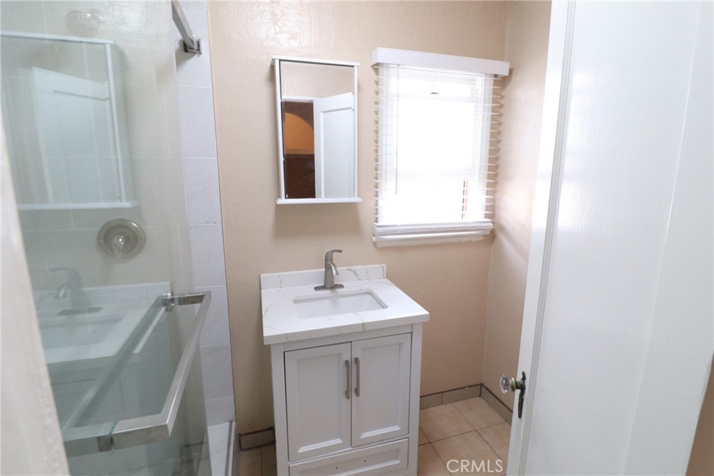 925 North Lacy Street, Unit 4 Santa Ana, CA 92701 - Photo 9 of 20 a bathroom with a sink a toilet and shower
