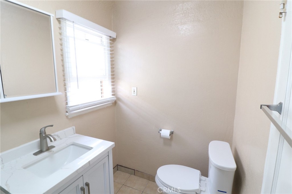 925 North Lacy Street, Unit 4 Santa Ana, CA 92701 - Photo 10 of 20 a white toilet sitting next to a bathroom sink