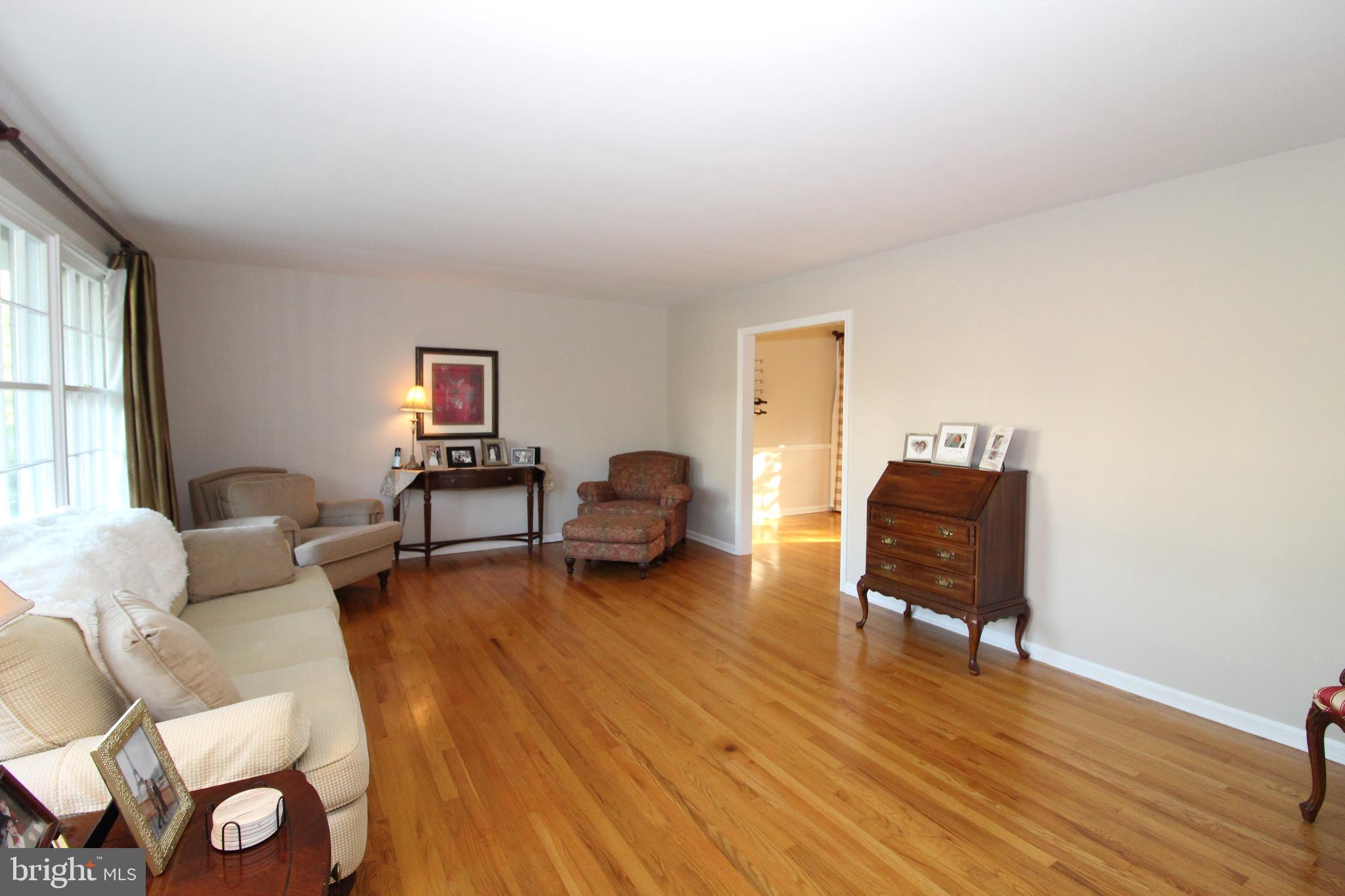 Spacious living area with warm wood floors.