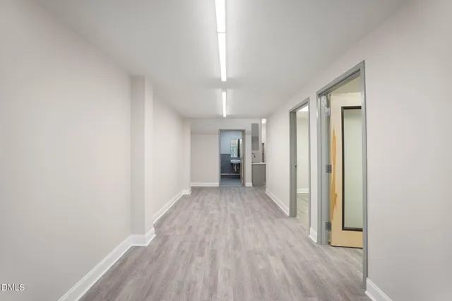 a kitchen with a sink a refrigerator and cabinets