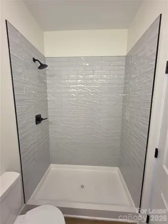 a bathroom with a shower and a toilet