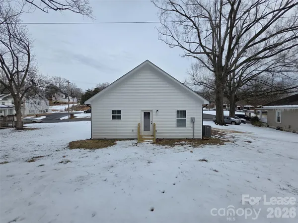 a view of a house with a snow in the yard