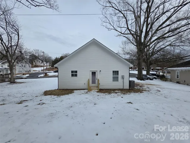 a view of a house with a snow in the yard