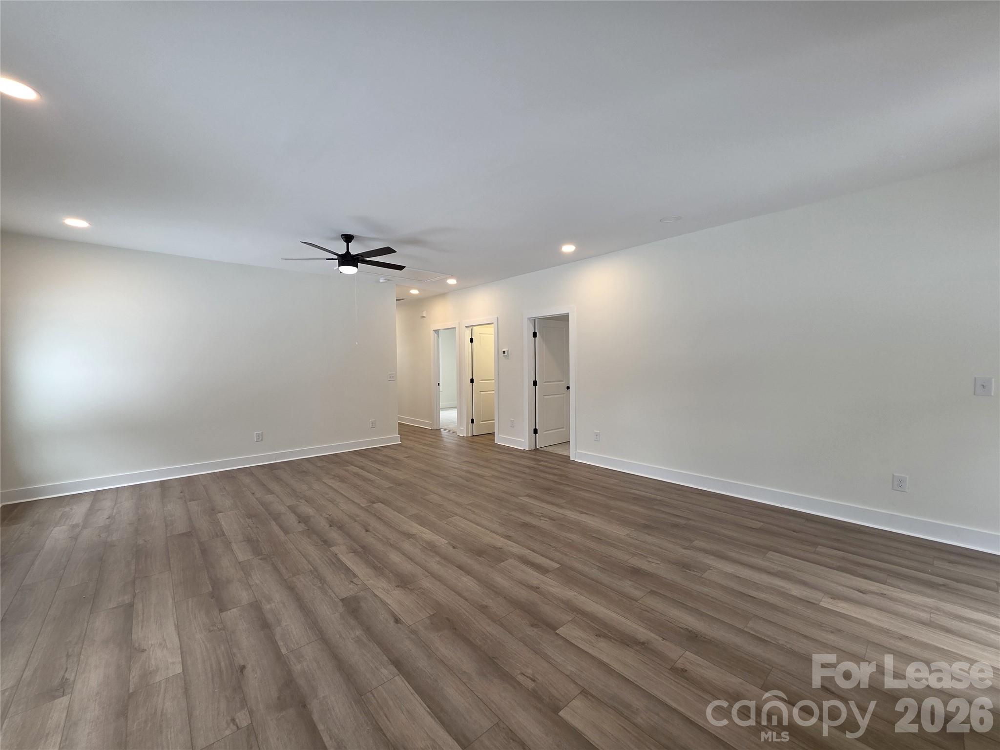 126 Heath Street Albemarle, NC 28001 - Photo 2 of 16 an empty room with wooden floor and windows