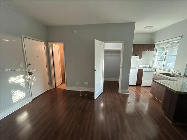 a view of a kitchen cabinets wooden floor and a kitchen