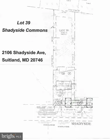 an empty room with wooden floor and kitchen view