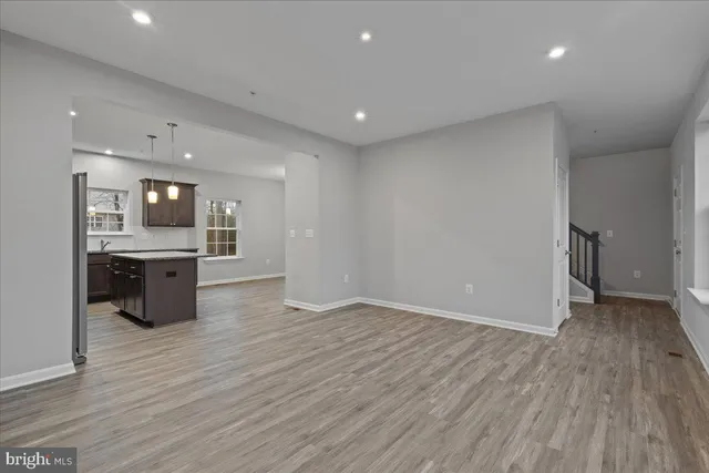 a kitchen with stainless steel appliances granite countertop a refrigerator a sink a stove a microwave and island