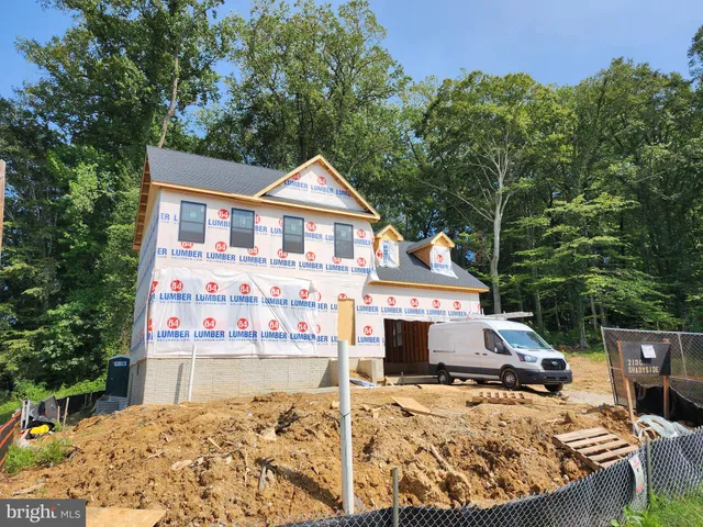 a view of a house with wooden fence
