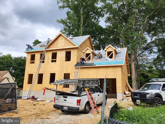 a view of a white house in front of a yard