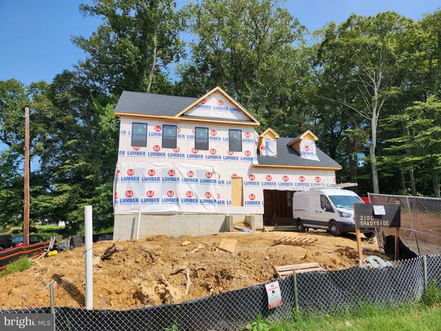 a view of a house with wooden deck patio and furniture