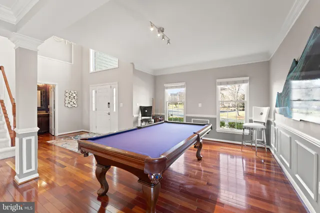 a kitchen with a stove a sink dishwasher and a refrigerator with wooden floor