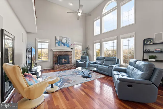 a view of a workspace with wooden floor and windows