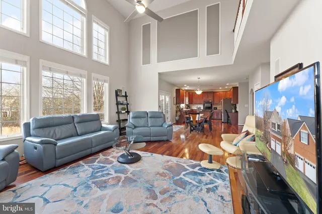 a spacious bedroom with a bed a mirror and window