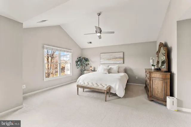 a view of a patio with couches table and chairs under an umbrella with wooden floor