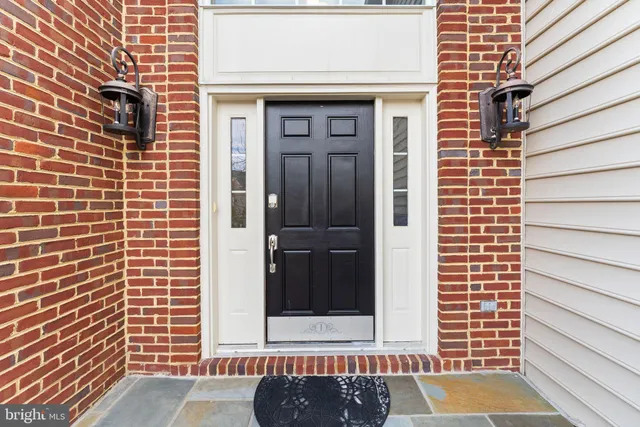 a living room with furniture fireplace and a large window