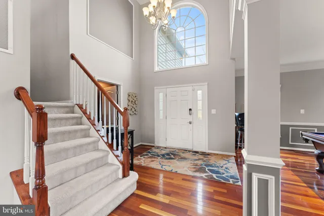 a living room with furniture fireplace and a large window