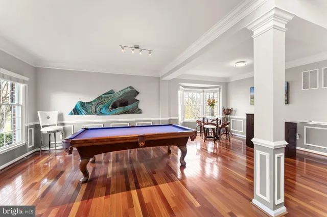 a bed sitting in a bedroom next to a window and a fireplace