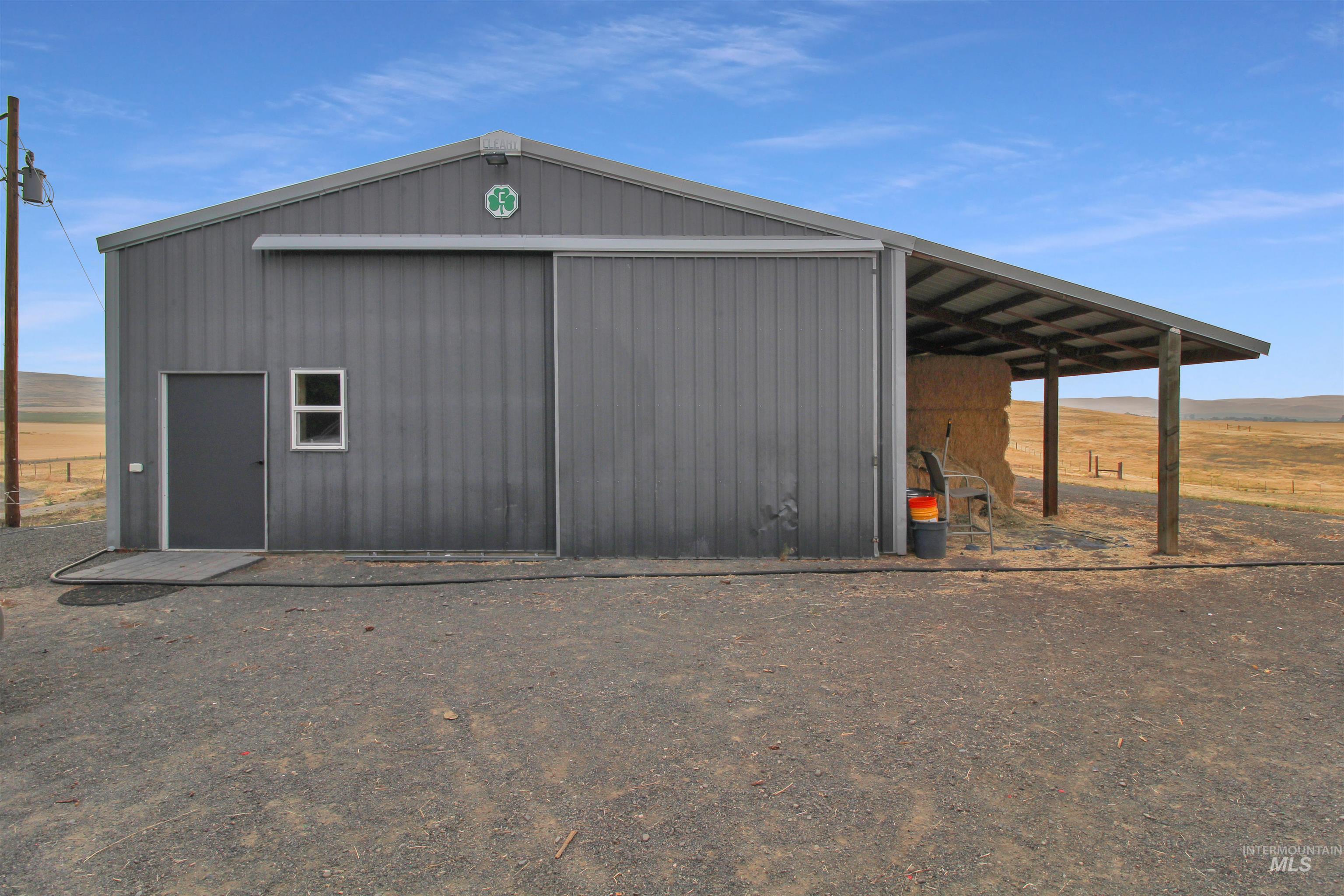 2469 Hague Road Midvale, ID 83645 - Photo 27 of 50 Metal-clad barn with a gabled roof and an attached lean-to structure