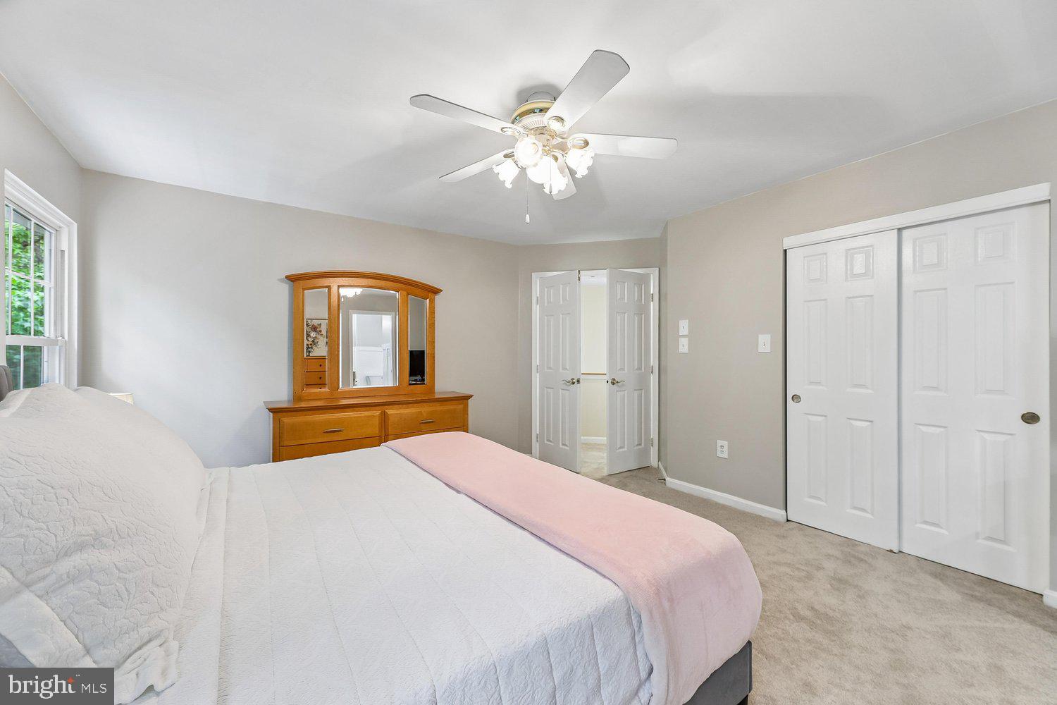 3707 Turn Back Trail Triangle, VA 22172 - Photo 30 of 55 a bedroom with a large bed and a chandelier