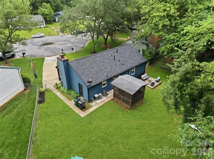an aerial view of a house with backyard