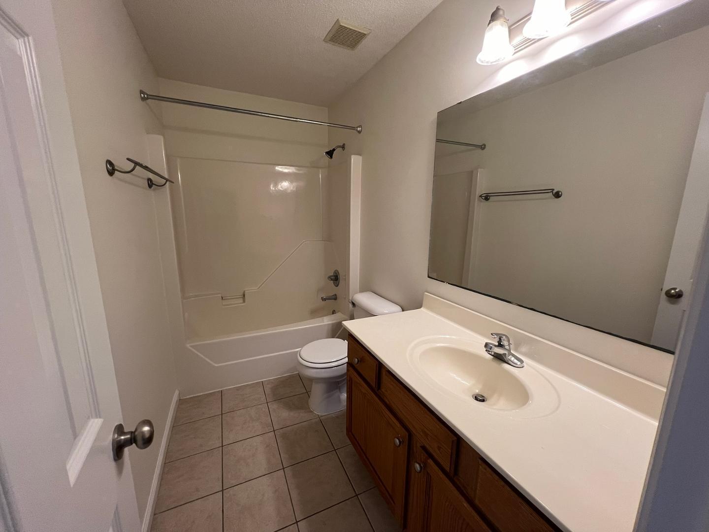 100 Dover Court East Sanford, NC 27332 - Photo 15 of 20 a bathroom with a sink mirror toilet and bathtub