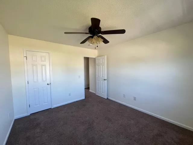 a view of a chandelier fan and hardwood floor