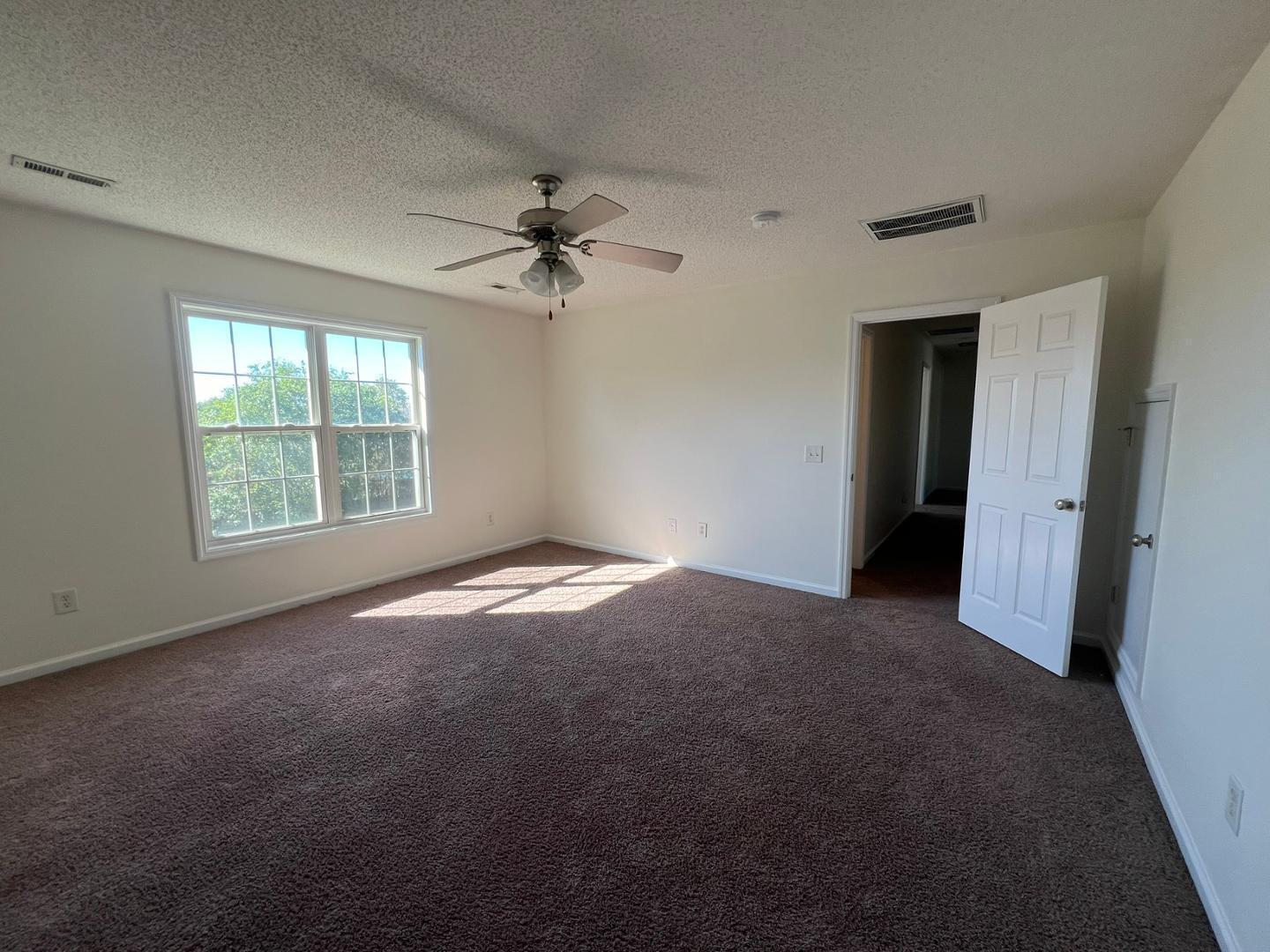 100 Dover Court East Sanford, NC 27332 - Photo 18 of 20 an empty room with windows and fan